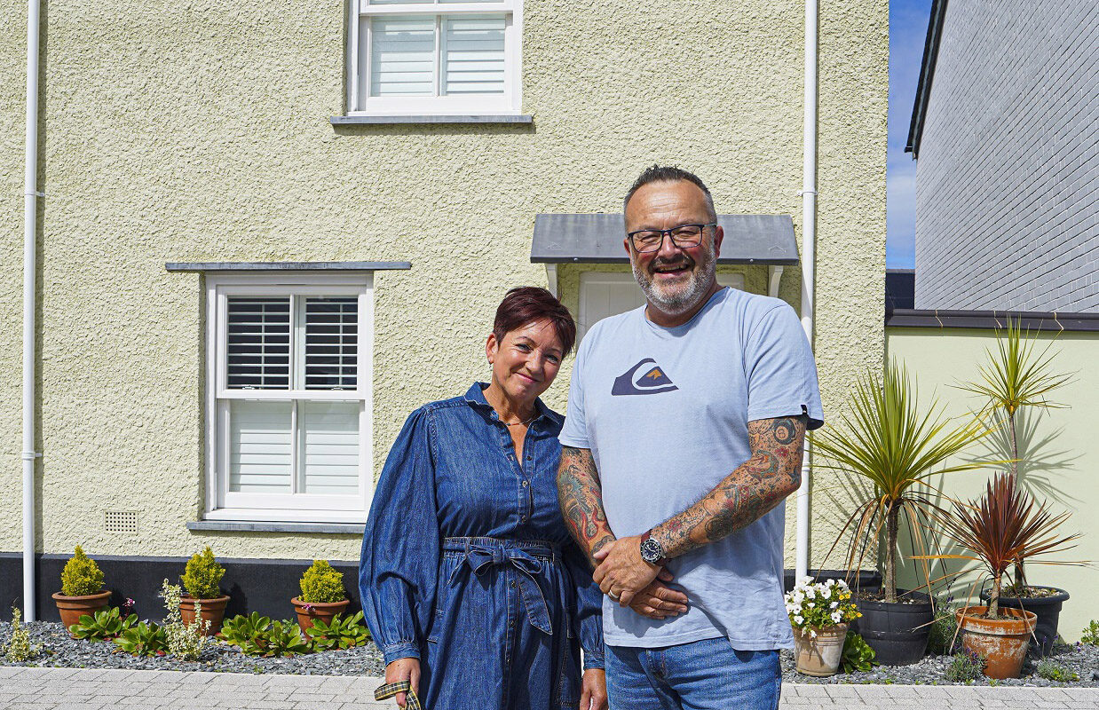 Graham and Mandy Lamb with the dog Stanley outside their Nansledan home. Credit Hugh Hastings.