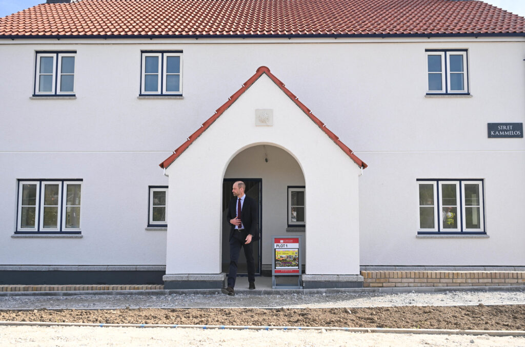 Duke Of Cornwall There Is A Man Standing Outside Of A House With A Sign
