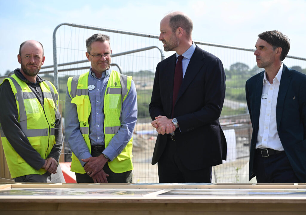 Duke Of Cornwall Three Men In Yellow Vests And Black Jackets Standing Around A Table