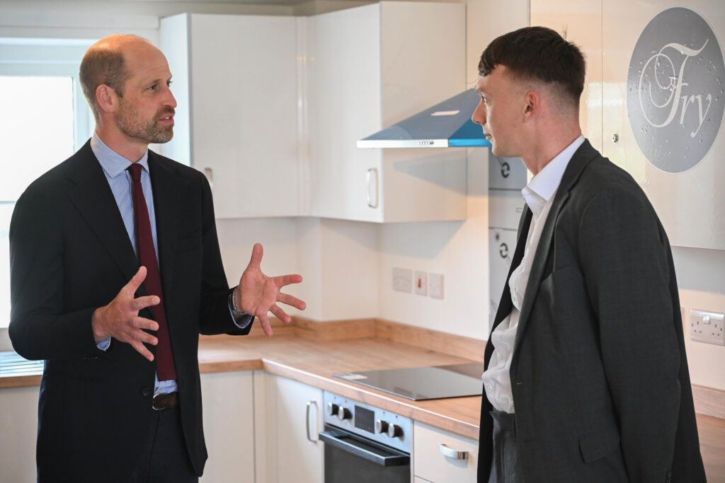Duke Of Cornwall Two Men In Suits Talking In A Kitchen With A Stove